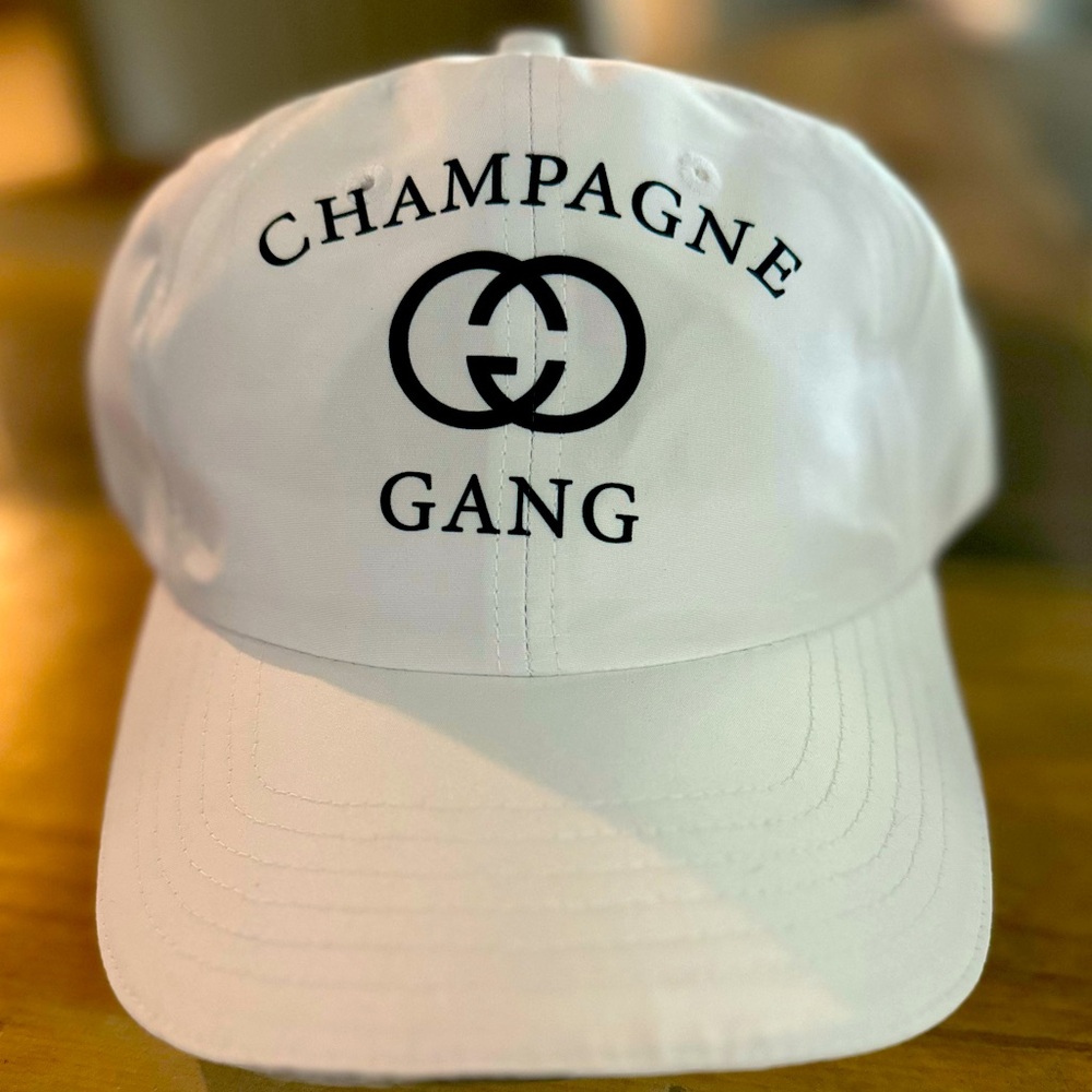 White Cap with Black “Champagne Gang” Design
Velcro closure 
Brand: Core 365